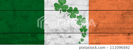 St. Patrick's Day background. Shamrocks against the background of the Irish flag. Decoration for St. Patrick's Day. St. Patrick's Day background. Shamrocks against the background of the Irish flag. Decoration for St. Patrick's Day. 111096892