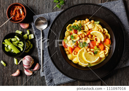 orecchiette pasta chickpea soup in black bowl 111097016
