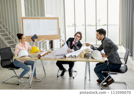 Engineer team meeting to inspect the construction blueprint drawings, work plan and distribute work before starting the building Engineer team meeting to inspect the construction blueprint drawings, work plan and distribute work before starting the building 111098070