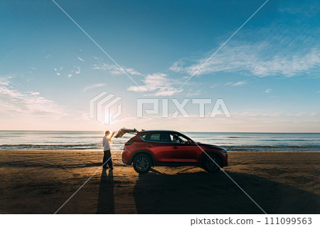 Red car and driver running on the coast 111099563
