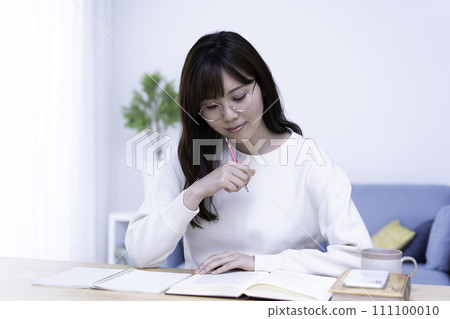 一位戴眼鏡的女士在明亮的客廳裡學習 111100010