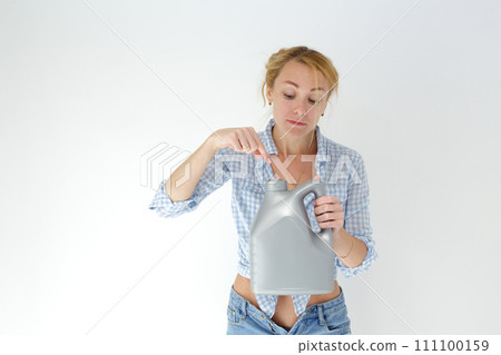 Woman holding canister of motor oil on light background Woman holding canister of motor oil on light background 111100159