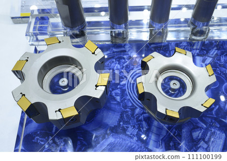 Modern double-sided inserts with long helical cutting edges, for milling, presented on stand. 111100199