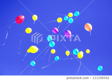 many multicolored balloons flying in the blue sky. Holiday accessories and decorations many multicolored balloons flying in the blue sky. Holiday accessories and decorations 111100582