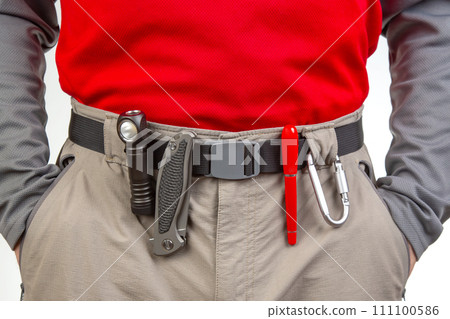 Pen, knife and flashlight with clips on the waistband of trekking pants. EDC items Pen, knife and flashlight with clips on the waistband of trekking pants. EDC items 111100586
