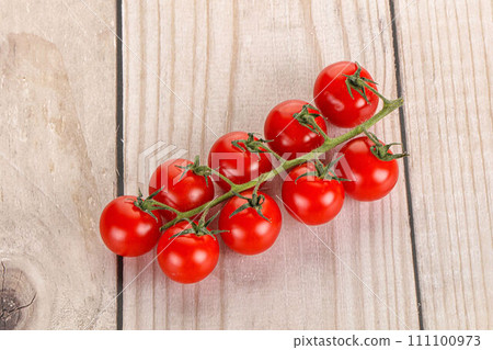 Ripe sweet cherry tomato branch 111100973