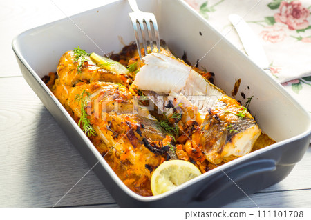 fish baked with spices and vegetables in the oven. fish baked with spices and vegetables in the oven. 111101708
