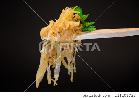cabbage stewed with spices and carrots on a wooden fork cabbage stewed with spices and carrots on a wooden fork 111101725