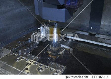 Electrical discharge machining. Electrical discharge machine EDM shapes metal by creating sparks. Electrical discharge machining. Electrical discharge machine EDM shapes metal by creating sparks. 111102094