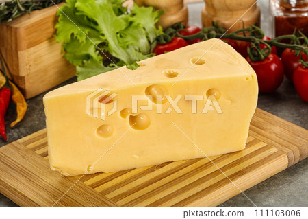 Swiss Maasdam cheese triangle over board 111103006