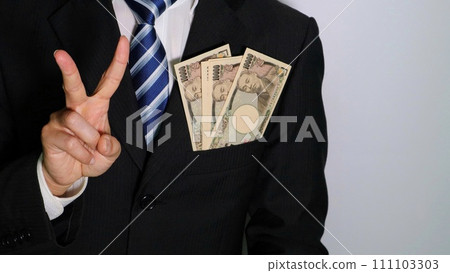 Businessman posing with money in his pocket 111103303