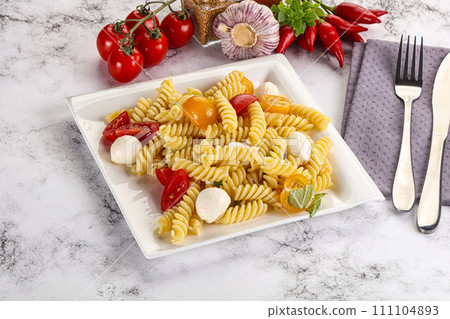 Italian pasta with mozzarella and tomato Italian pasta with mozzarella and tomato 111104893