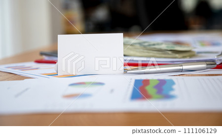 Strategic Business Planning,Blank Name Cards and Pen on a Sales Performance Chart 111106129