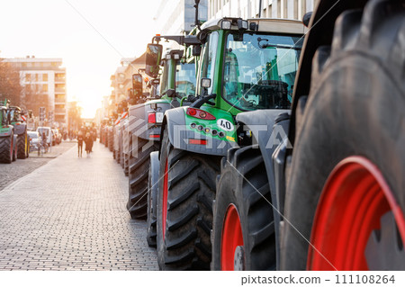 Farmers union protest strike against government Policy in Germany Europe. Tractors vehicles blocks city road traffic. Agriculture farm machines Magdeburg central Domplatz square 111108264