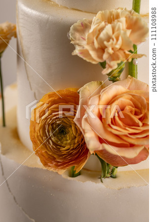 Peach colored flowers in wedding cake Peach colored flowers in wedding cake 111108988