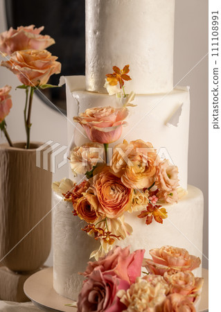 Cake with peach fuzz colored flowers Cake with peach fuzz colored flowers 111108991