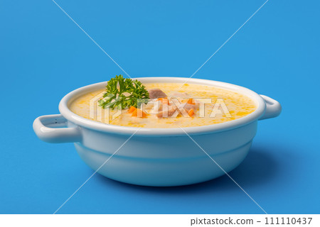 Chicken soup bowl close-up, isolated on a blue background Chicken soup bowl close-up, isolated on a blue background 111110437