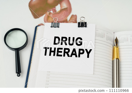 On the table there is a magnifying glass and a notepad with the inscription - Drug Therapy 111110966