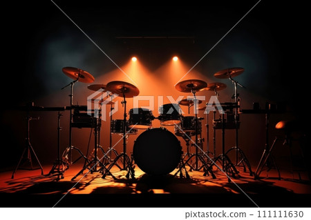 Drum set on stage illuminated by red and orange lights ready to perform. Drum kit on dark background. Ideal for music-related content. Musical percussion instrument. 111111630