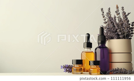 Beauty product display, slender flacons and oils, arranged with fresh lavender, on a monochrome ivory surface Beauty product display, slender flacons and oils, arranged with fresh lavender, on a monochrome ivory surface 111111956