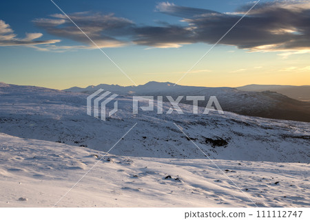 Snowy mountains during early sunset, Iceland Snowy mountains during early sunset, Iceland 111112747