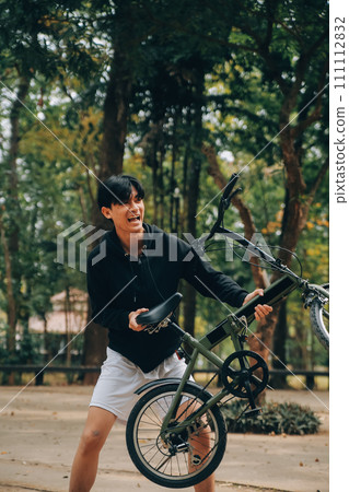 Handsome happy young man with bicycle on a city street, Active lifestyle, people concept 111112832