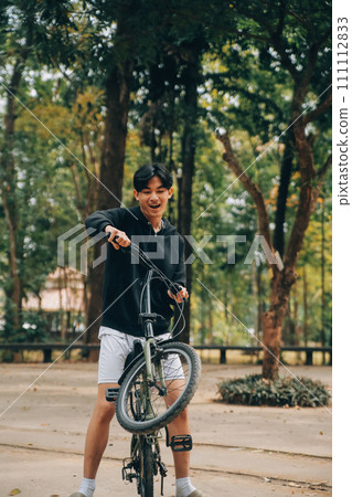 Handsome happy young man with bicycle on a city street, Active lifestyle, people concept Handsome happy young man with bicycle on a city street, Active lifestyle, people concept 111112833