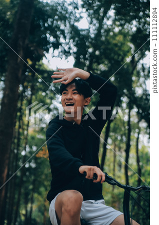 Handsome happy young man with bicycle on a city street, Active lifestyle, people concept 111112894
