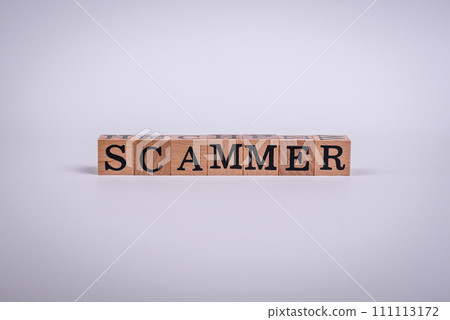 The inscription Scammer made of wooden cubes on a plain background The inscription Scammer made of wooden cubes on a plain background 111113172