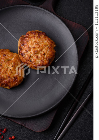 Delicious fresh fried minced fish cutlets with spices and herbs Delicious fresh fried minced fish cutlets with spices and herbs 111113198