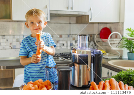Child Making Fresh Carrot Juice at Home Child Making Fresh Carrot Juice at Home 111113479