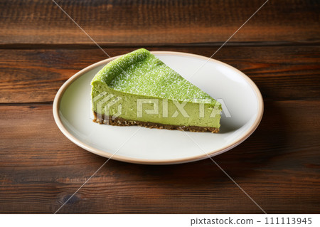 A slice of cheesecake with japanese matcha green tea on the white plate 111113945