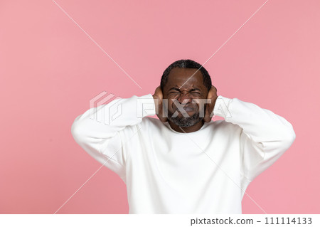 Nervous black man wearing white sweatshirt covering ears 111114133