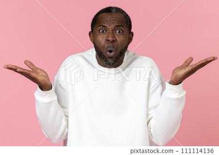 Surprised black man wearing white sweatshirt shrugging shoulders Surprised black man wearing white sweatshirt shrugging shoulders 111114136