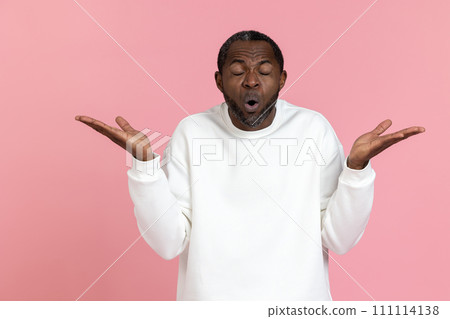 Shocked black man wearing white sweatshirt shrugging shoulders Shocked black man wearing white sweatshirt shrugging shoulders 111114138
