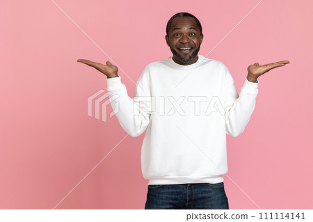Cheerful black man wearing white sweatshirt presenting copy space on palms Cheerful black man wearing white sweatshirt presenting copy space on palms 111114141