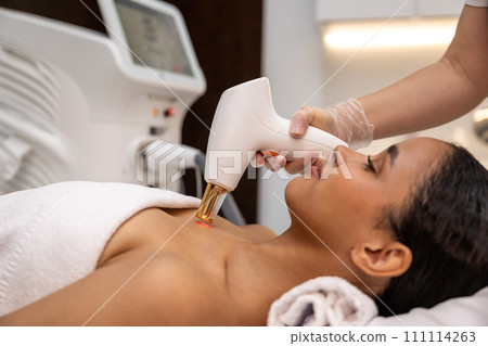 Woman having face resurfacing in a beauty salon 111114263