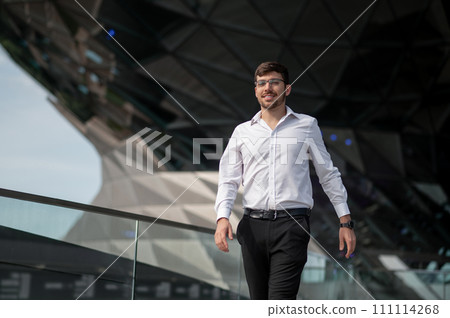 Good-looking young man in elegant outfit on urban background Good-looking young man in elegant outfit on urban background 111114268