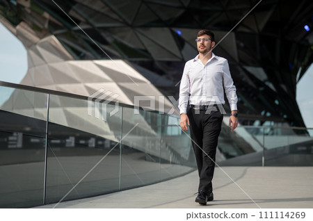 Good-looking young man in elegant outfit on urban background 111114269