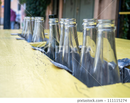 Decorative empty bottles. Table at the bar on the street. Bar decoration. Decorative empty bottles. Table at the bar on the street. Bar decoration. 111115274