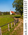 Scenic landscape of historic church and farm lands in Bavaria rural side. 111115597