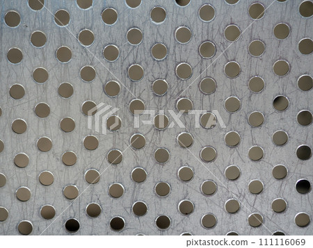 Metal surface in a hole. Leaky iron. Metal background. The surface of the seat at the station. Metal surface in a hole. Leaky iron. Metal background. The surface of the seat at the station. 111116069