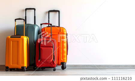 Colorful travel suitcases on a wooden floor against a white wall. Colorful travel suitcases on a wooden floor against a white wall. 111116210