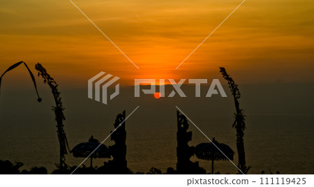 views of Penjor, Janur and Baliviews of Penjor, Janur and Balinese temples with a beautiful sunset in the backgroundnese temples with a beautiful sunset in the background 111119425
