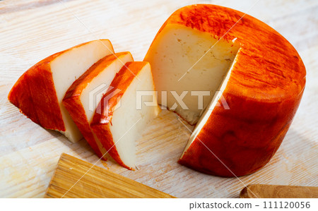 Image of goat cheese with pepper on wooden desk 111120056