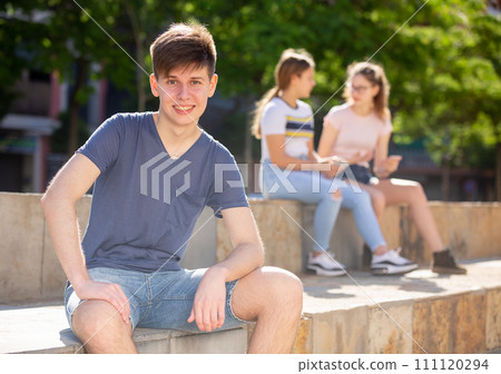 Cheerful teenager enjoying summer day on city street 111120294