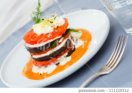 Fried eggplant pyramid with tomatoes on spicy sauce Fried eggplant pyramid with tomatoes on spicy sauce 111120312