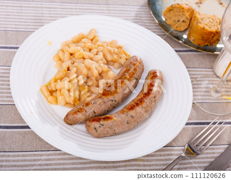 Fried botifarra sausage served with cooked white beans 111120626