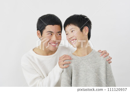 Close teenage brothers white background Close teenage brothers white background 111120937