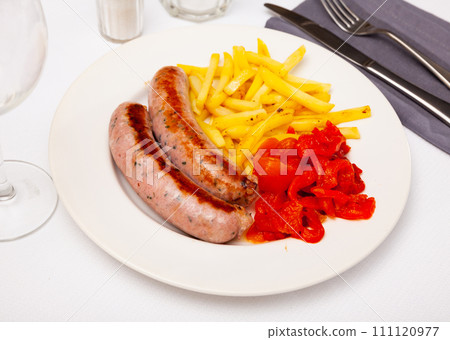 Tasty fried pork sausages with baked potatoes and pepper Tasty fried pork sausages with baked potatoes and pepper 111120977